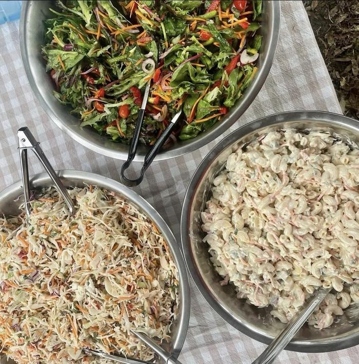 Fresh garden salad, coleslaw and pasta salad ready to serve